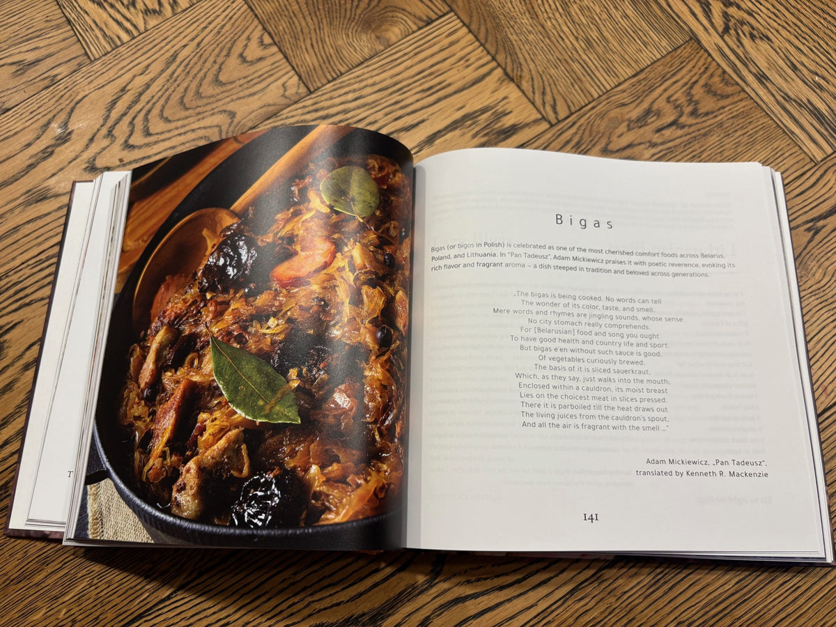 The Belarusian Cookbook open at the bigas spread, with a photograph of the hunter's stew