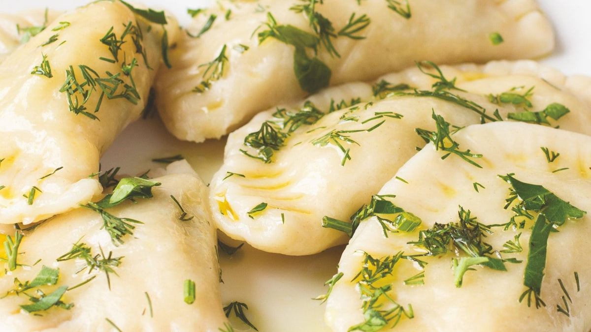 Filled dumplings with melted butter and dill, a photograph from The Belarusian Cookbook